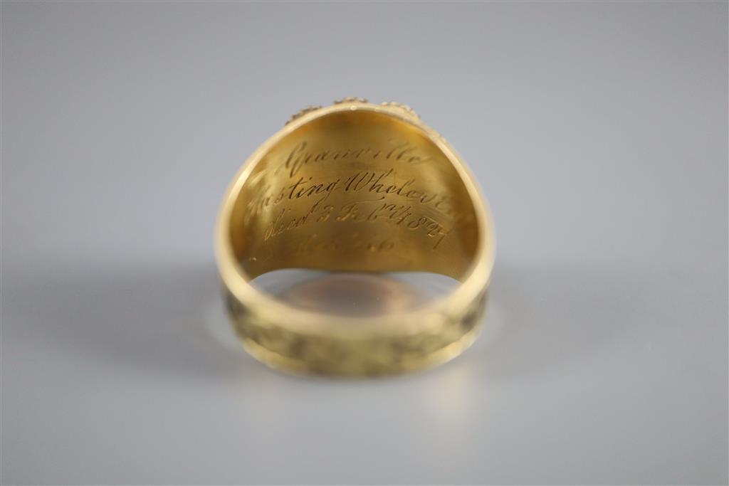 A George IV gold, black enamel, oval cut foil backed garnet and split pearl cluster set mourning ring,